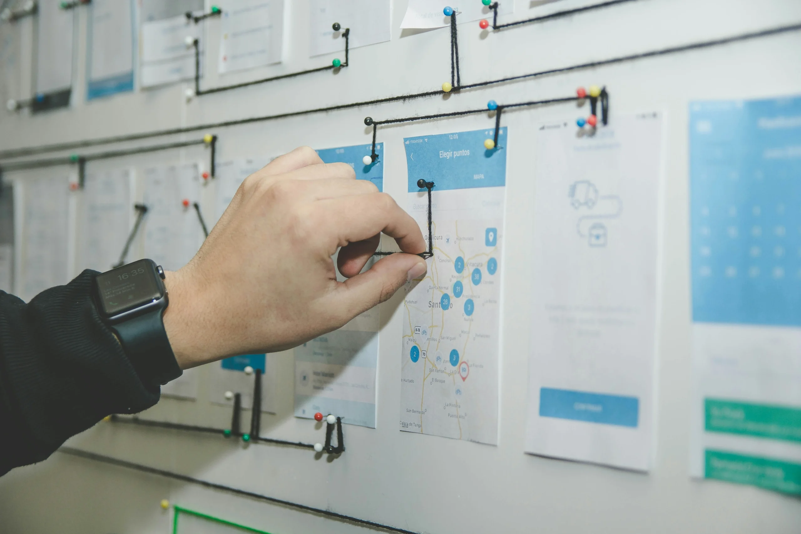  A person pointing to a whiteboard filled with information, ideal for graphic designing companies in Thrissur.